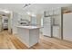 Spacious kitchen with island, white cabinets, and modern appliances at 1401 W Highway 50 # 143, Clermont, FL 34711