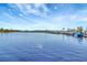 Scenic lake view with blue sky, wispy clouds, and waterfront mobile home community at 1401 W Highway 50 # 143, Clermont, FL 34711