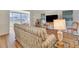 Inviting living room with hardwood floors, comfortable sofa, and a TV at 1401 W Highway 50 # 143, Clermont, FL 34711