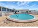 Community pool surrounded by ample seating for residents to enjoy under blue skies at 1401 W Highway 50 # 143, Clermont, FL 34711