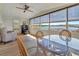 Open sunroom overlooking the lake has wicker chairs, ceiling fan and beautiful natural light at 1401 W Highway 50 # 143, Clermont, FL 34711
