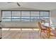 Lake view sunroom has wicker chairs, ceiling fan, and stunning water views at 1401 W Highway 50 # 143, Clermont, FL 34711