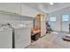 Utility room featuring a washing machine, dryer, refrigerator, and a window at 1401 W Highway 50 # 143, Clermont, FL 34711