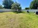 A spacious backyard with green grass, shed, white fence, and a shade tree at 14657 Sw 41St Ave, Ocala, FL 34473