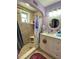 Bathroom featuring tiled shower, vanity and mirror, decorated with purple accents at 14657 Sw 41St Ave, Ocala, FL 34473
