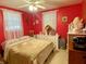 Inviting bedroom with red walls, a cozy bed, and soft natural light at 14657 Sw 41St Ave, Ocala, FL 34473