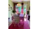 Cozy dining room with white table and chairs, decorative chandelier, and bright pink rug at 14657 Sw 41St Ave, Ocala, FL 34473