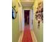 Hallway with light wood floors and green walls leads to additional rooms at 14657 Sw 41St Ave, Ocala, FL 34473