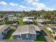 Bright aerial shot showcases a well-maintained mobile home community, lush trees, and homes under sunny skies at 150 Hickory Ln, Eustis, FL 32726
