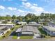 A pleasant aerial view of the neighborhood showing a single story home with mature landscaping and a double carport at 150 Hickory Ln, Eustis, FL 32726