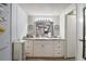 Bathroom features a marble countertop, large mirror, and white cabinets at 150 Hickory Ln, Eustis, FL 32726
