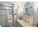 Bathroom featuring a step-in shower with glass doors, large vanity, and bright lighting with coastal decor at 150 Hickory Ln, Eustis, FL 32726