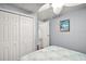 Bright bedroom featuring a closet, ceiling fan, coastal decor, and a starfish themed comforter at 150 Hickory Ln, Eustis, FL 32726