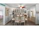 Open dining room with glass table, seating for six, and unique storage features at 150 Hickory Ln, Eustis, FL 32726