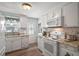 Bright, efficient kitchen with white cabinetry, granite counters, and updated appliances at 150 Hickory Ln, Eustis, FL 32726