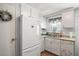 Bright kitchen with white appliances, granite countertops, a stainless steel sink, and ample cabinet space at 150 Hickory Ln, Eustis, FL 32726