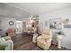 Comfortable living room with wood-look flooring and neutral color scheme offering access to the sunroom at 150 Hickory Ln, Eustis, FL 32726