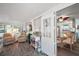 Open living area with wood-look floors leading to the dining room and featuring a door to the sunroom at 150 Hickory Ln, Eustis, FL 32726