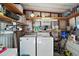 Organized storage area with a washer, dryer, and shelving for various supplies at 150 Hickory Ln, Eustis, FL 32726