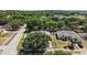 Aerial view of the property and neighborhood showcasing mature trees at 1554 Sarus Ave, Groveland, FL 34736
