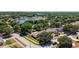 An aerial view of a neighborhood highlighting a home near a scenic lake at 1554 Sarus Ave, Groveland, FL 34736