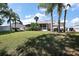 Expansive backyard with lush lawn, a patio, and screened lanai offering space to enjoy the outdoors at 1554 Sarus Ave, Groveland, FL 34736