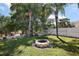 Backyard featuring a hammock, and fire pit, offering a relaxing space for outdoor enjoyment at 1554 Sarus Ave, Groveland, FL 34736