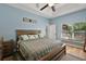 This primary bedroom has a cozy design, vaulted ceiling, and a large window with natural light at 1554 Sarus Ave, Groveland, FL 34736