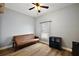 Well-lit bedroom with wood-look floors and a large window providing natural light at 1554 Sarus Ave, Groveland, FL 34736
