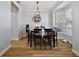 Inviting dining room with a bay window, modern lighting, and hardwood floors at 1554 Sarus Ave, Groveland, FL 34736