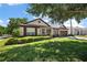 Charming home with lush green lawn and well-maintained landscaping creates a welcoming curb appeal at 1554 Sarus Ave, Groveland, FL 34736