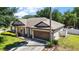 Charming single-Gathering home with an attached garage, well-manicured lawn, and lovely landscaping at 1554 Sarus Ave, Groveland, FL 34736