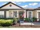 Close up of a home's front entrance landscaped with lovely plants and charming decorations at 1554 Sarus Ave, Groveland, FL 34736