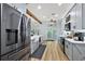 Bright, open kitchen with stainless steel appliances, sleek cabinets, and contemporary design at 1554 Sarus Ave, Groveland, FL 34736