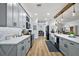 Bright kitchen featuring modern gray cabinets, stainless steel appliances, and hardwood floors at 1554 Sarus Ave, Groveland, FL 34736