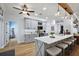 An open kitchen features gray cabinets, quartz countertops, stainless appliances, a large island, and a breakfast bar at 1554 Sarus Ave, Groveland, FL 34736