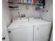 Functional laundry area with washer, dryer, and shelving for organized storage solutions at 1554 Sarus Ave, Groveland, FL 34736