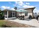 Outdoor patio area with an umbrella table and grill, ideal for entertaining and enjoying backyard views at 1554 Sarus Ave, Groveland, FL 34736