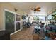 Spacious sunroom with tile flooring and inviting seating area, perfect for enjoying indoor-outdoor living at 1554 Sarus Ave, Groveland, FL 34736