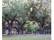 Spacious backyard framed by mature trees and fenced perimeters, enhancing privacy and natural beauty at 1650 Sundance Dr, St Cloud, FL 34771