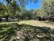Expansive backyard featuring mature trees, providing ample shade and natural beauty to the property at 1650 Sundance Dr, St Cloud, FL 34771