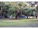 Well-maintained backyard with mature trees, enclosed area and partial fencing, and lots of open space at 1650 Sundance Dr, St Cloud, FL 34771