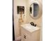 Charming bathroom featuring a vanity with a round mirror, decorative wall hangings, and modern fixtures at 1650 Sundance Dr, St Cloud, FL 34771