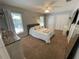 Spacious bedroom with carpet, two large closets, two windows for ample natural light, and ceiling fan at 1650 Sundance Dr, St Cloud, FL 34771
