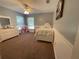 Cozy bedroom with carpeted floor, ceiling fan, and a large window providing natural light at 1650 Sundance Dr, St Cloud, FL 34771