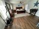 Comfortable bedroom with wood floors, ceiling fan and exercise equipment at 1650 Sundance Dr, St Cloud, FL 34771