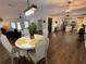 Open-concept dining area featuring a round table, stylish chairs, and hardwood floors with views of the living and kitchen areas at 1650 Sundance Dr, St Cloud, FL 34771
