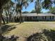 Charming one-story home featuring a covered porch and well-maintained front yard with mature trees and attractive landscaping at 1650 Sundance Dr, St Cloud, FL 34771