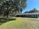 Spacious single-story home with a well-maintained lawn, covered porch, and a serene, tree-lined setting at 1650 Sundance Dr, St Cloud, FL 34771