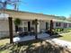 Inviting front porch with wooden pillars, comfortable seating, and decorative plants creating a welcoming entrance at 1650 Sundance Dr, St Cloud, FL 34771